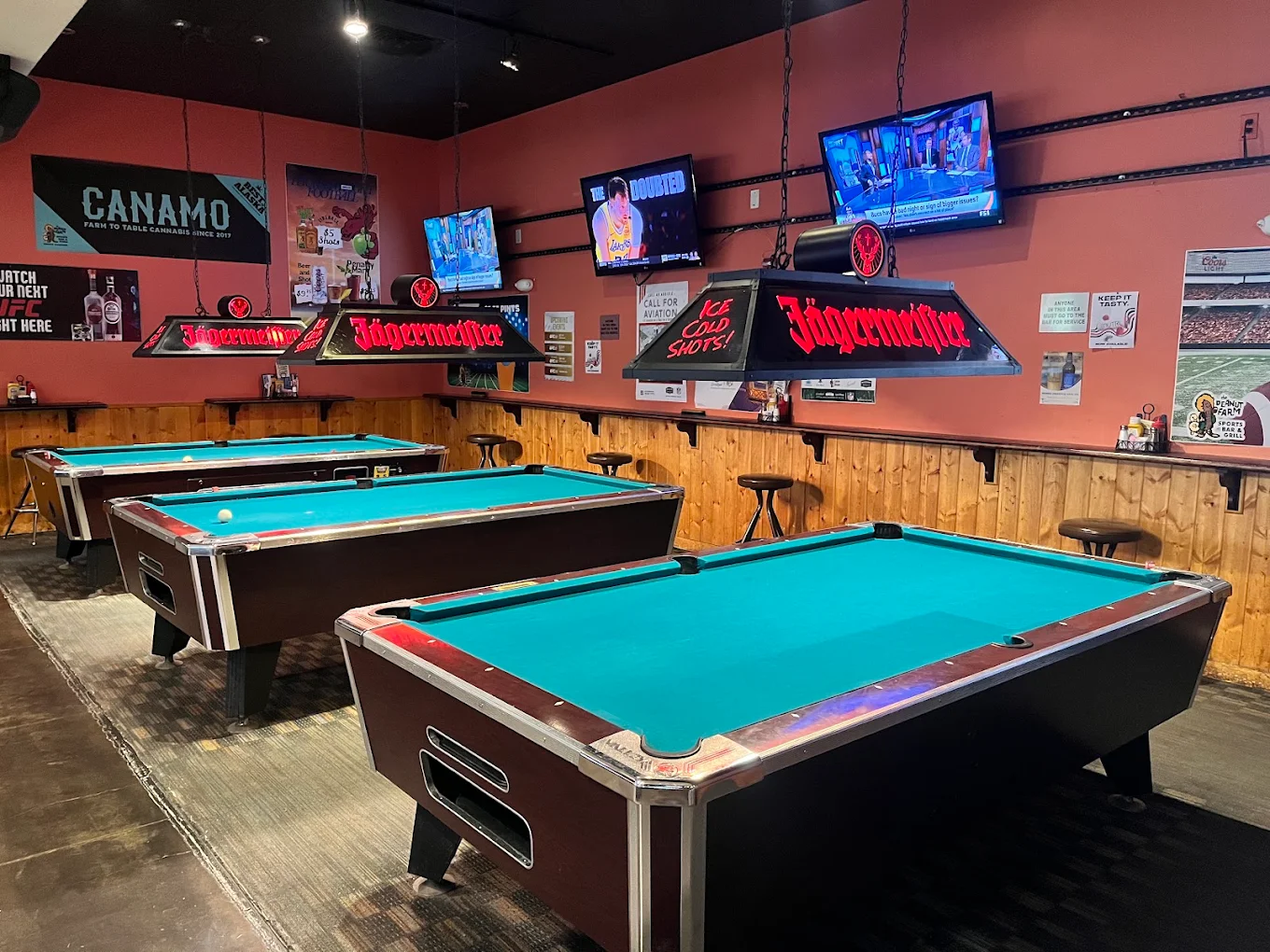 Pool tables and screens inside The Peanut Farm