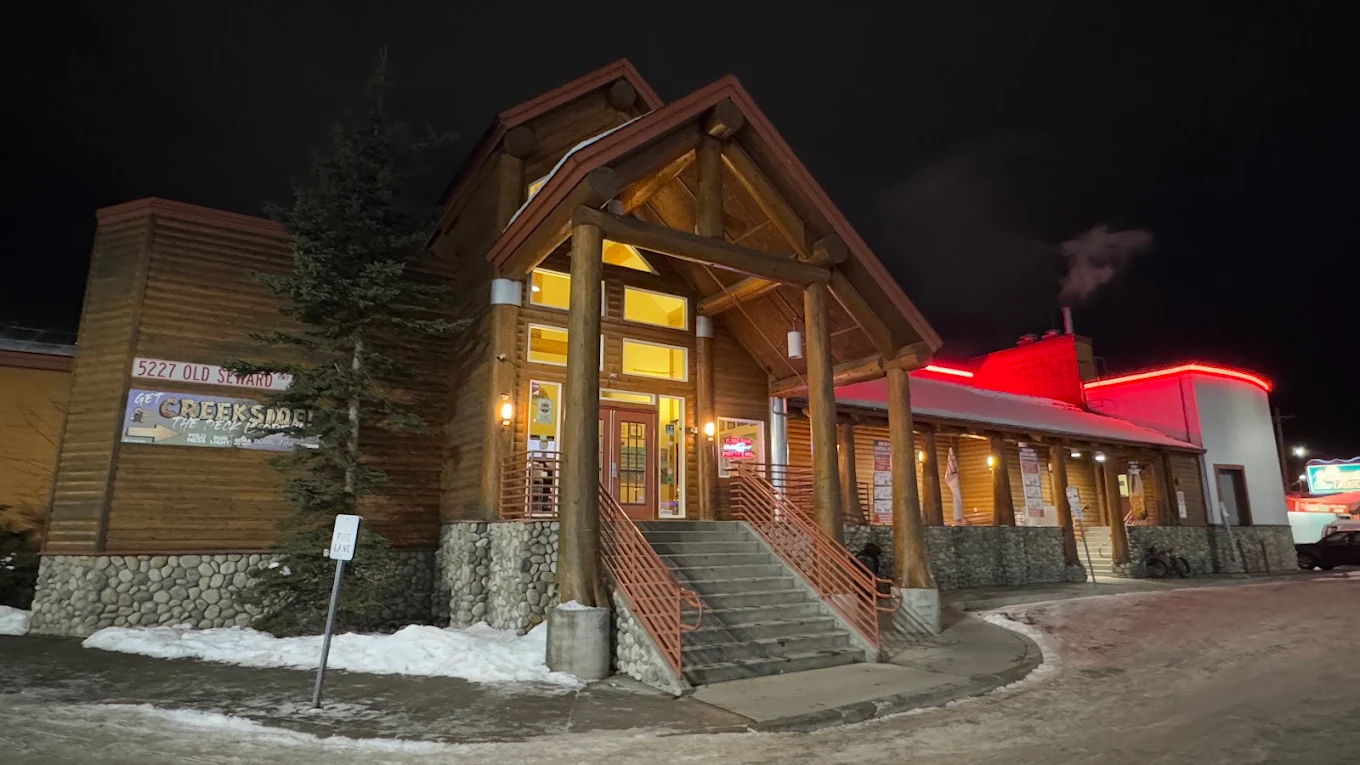 The Peanut Farm log cabin exterior at night